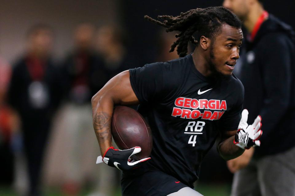 Georgia running back James Cook (4) runs a drill during Georgia's Pro Day in Athens, Ga., on Wednesday, March 16, 2022.