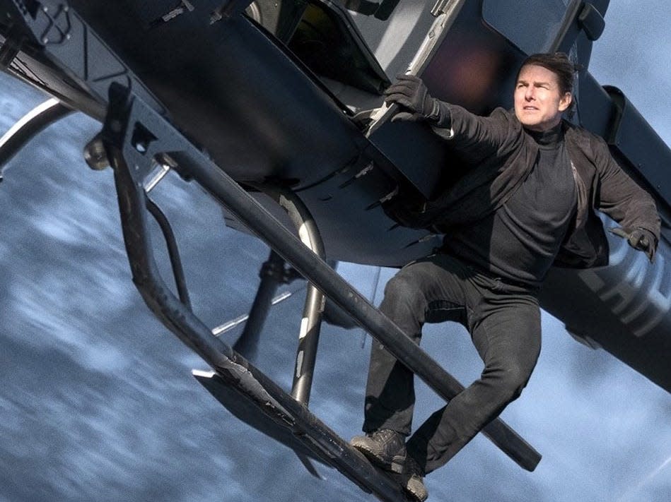 Tom Cruise hangs on to the side of a helicopter in "Mission Impossible: Fallout."