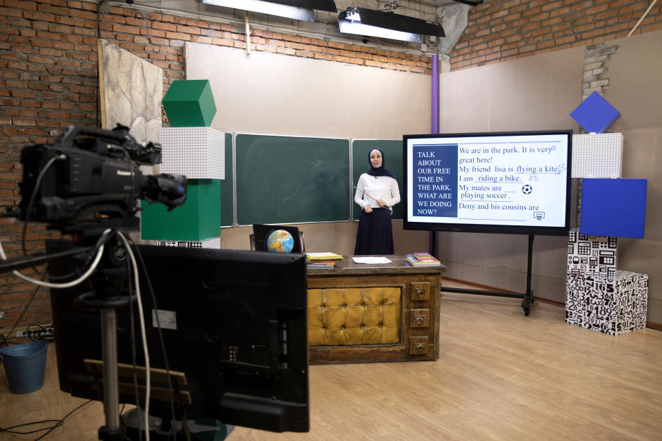 An English teacher conducts a lesson as part of the Teleshkola remote schooling project on Chechen television.