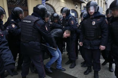 Policemen detain a man during an unsanctioned anti-government protest in Moscow, Russia, April 2, 2017. REUTERS/Maxim Shemetov