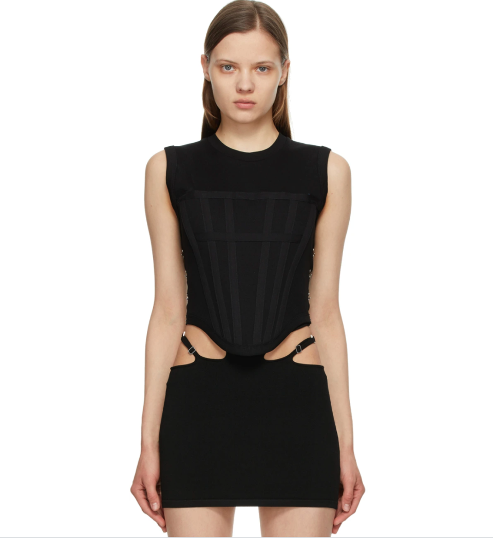 model wearing black cut out Dion Lee top and skirt