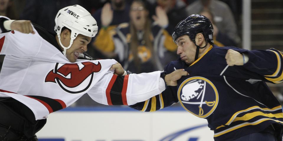 FILE - New Jersey Devils' Mark Fraser fights with Buffalo Sabres' Cody McCormick during the first period of an NHL hockey game in Buffalo, N.Y., Oct. 13, 2010. (AP Photo/David Duprey, File)