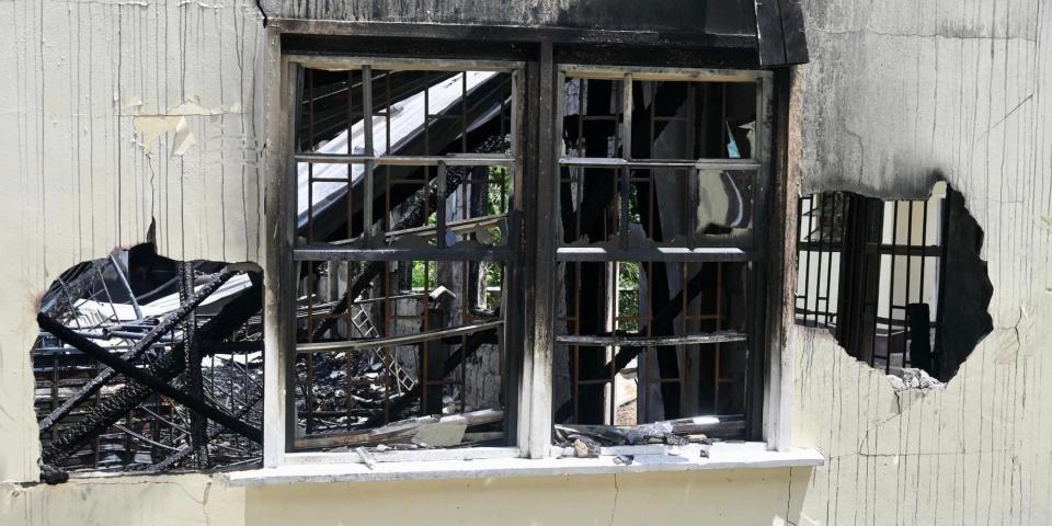 A charred window frame of the dormitory of Mahdia Secondary School in Guyana after a massive blaze on May 21, 2023.