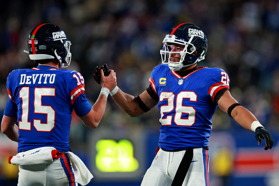 Dec 11, 2023; East Rutherford, New Jersey, USA; New York Giants running back Saquon Barkley (26) celebrates with quarterback Tommy DeVito (15) after scoring a touchdown during the third quarter against the Green Bay Packers at MetLife Stadium. Mandatory Credit: Vincent Carchietta-USA TODAY Sports