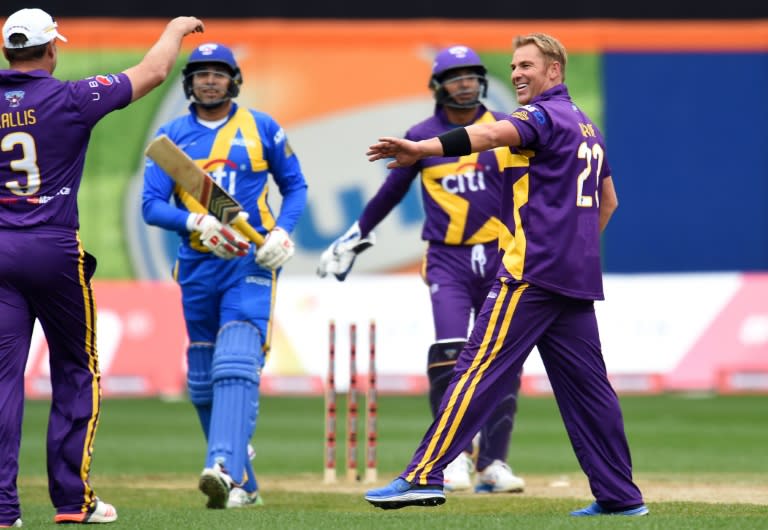 Warne's Warriors captain Shane Warne (R) celebrates after dismissing Sachin's Blasters batman VVS Laxman during the first of a three-match T20 series at the Citi Field in New York on November 7, 2015