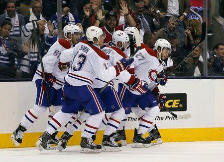 Oct 7, 2015; Toronto, Ontario, CAN; Montreal Canadiens forward Alex Galchenyuk (27) leads his teammates to the bench after his goal against the Toronto Maple Leafs at the Air Canada Centre. John E. Sokolowski-USA TODAY Sports