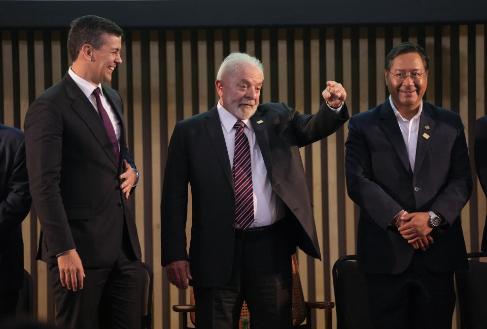 Brazilian President Luiz Inacio Lula da Silva, center, speaks with to the media as Parguay's President Santiago Pena, left, and Bolivia's President Luis Arce smile during the 63rd Mercosur Summit, in Rio de Janeiro, Brazil, Thursday, Dec. 7, 2023. (AP Photo/Silvia Izquierdo)