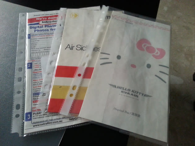 A Qantas Airways barf bag that doubles as an envelope for returning travellers to send their photos to be developed, an old Malaysia-Singapore Airlines barf bag that dates back to the late 60s, a special Hello Kitty barf bag from Taiwan’s EVA Air. (Yahoo! photo/Fann Sim)
