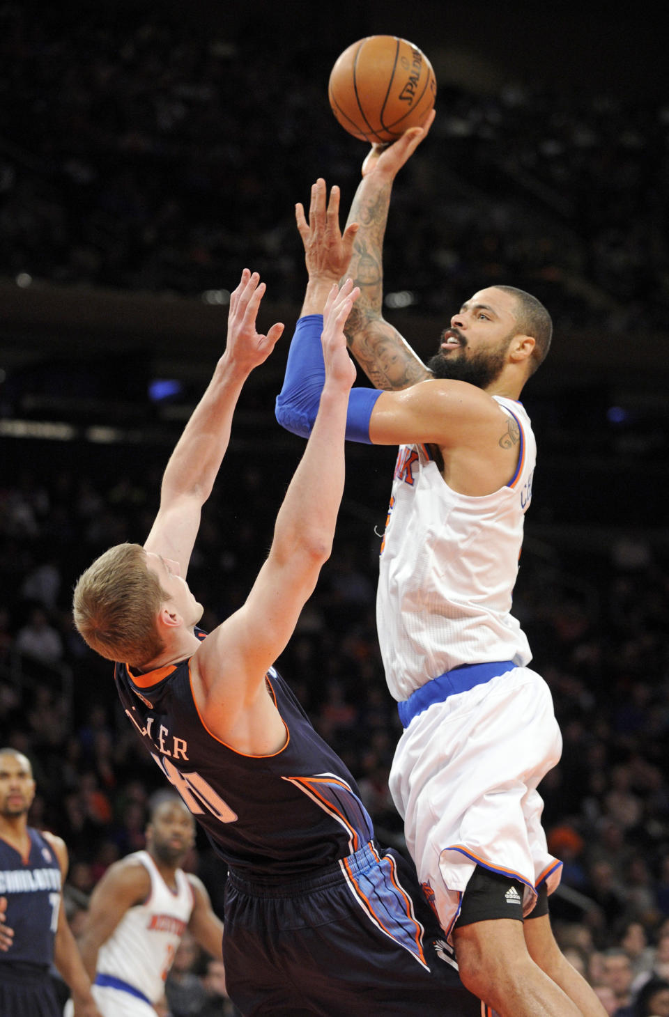 New York Knicks' Tyson Chandler, right, pits up a shot over Charlotte Bobcats' Cody Zeller during the first quarter of an NBA basketball game, Friday, Jan. 24, 2014, at Madison Square Garden in New York. The Knicks won 125-96. (AP Photo/Bill Kostroun)