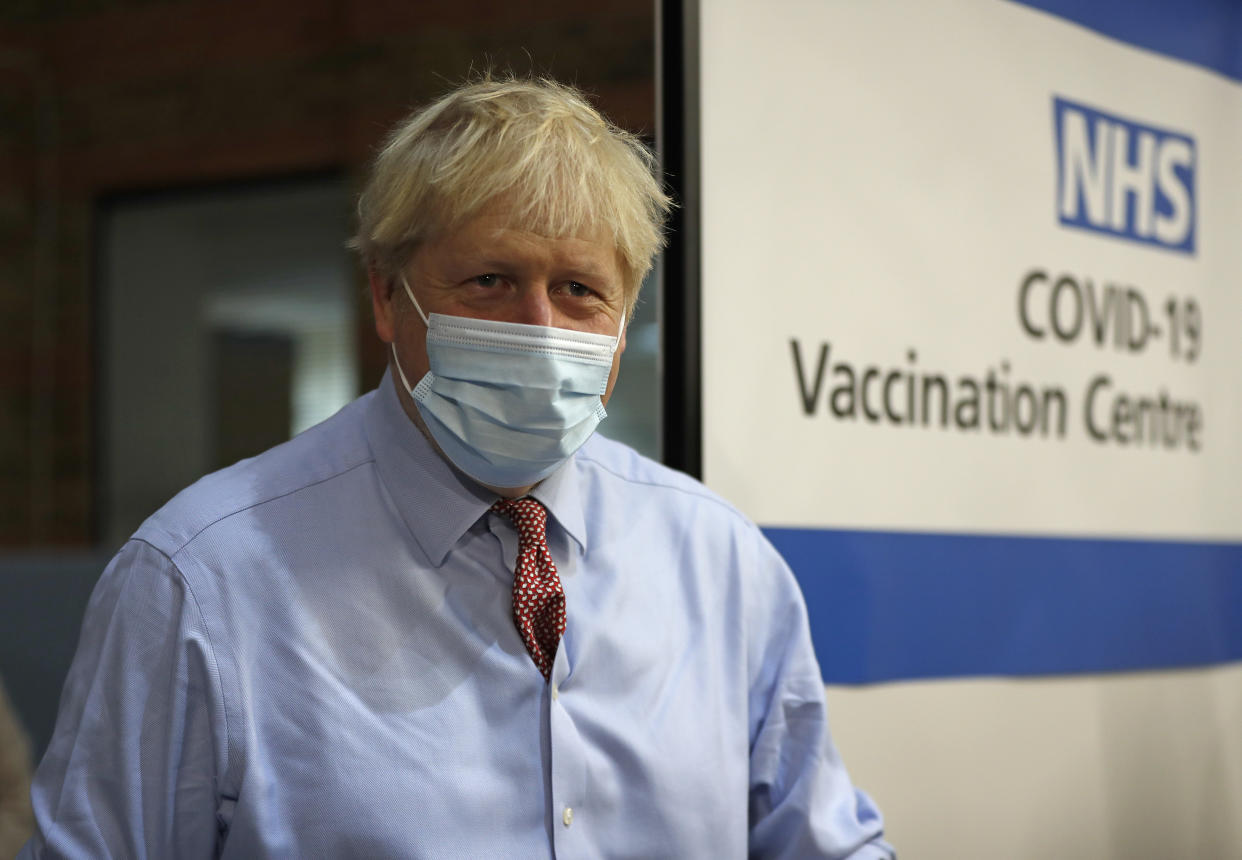 British Prime Minister Boris Johnson looks on after nurse Rebecca Cathersides administered the Pfizer-BioNTech COVID-19 vaccine to Lyn Wheeler at Guy&#39;s Hospital in London, Tuesday, Dec. 8, 2020. U.K. health authorities rolled out the first doses of a widely tested and independently reviewed COVID-19 vaccine Tuesday, starting a global immunization program that is expected to gain momentum as more serums win approval. (AP Photo/Frank Augstein, Pool)