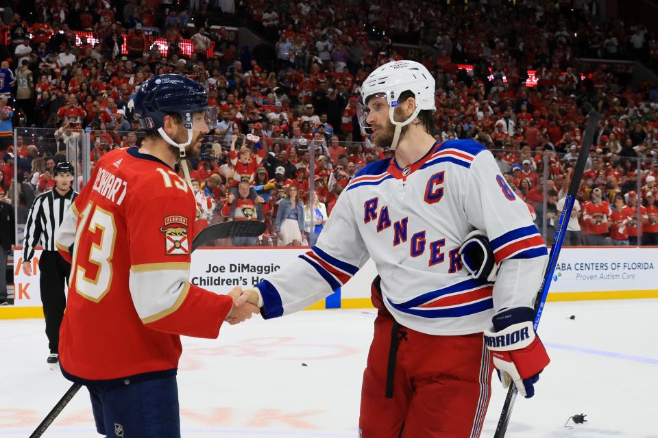 SUNRISE, FLORIDA - JUNE 01: Sam Reinhart #13 of the Florida Panthers shakes hands with Jacob Trouba #8 of the New York Rangers after Game Six of the Eastern Conference Final of the 2024 Stanley Cup Playoffs at Amerant Bank Arena on June 01, 2024 in Sunrise, Florida.