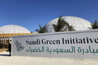 Two large tents are seen behind a sign for the Saudi Green Initiative near the COP27 climate conference venue, Friday, Nov. 11, 2022, in Sharm el-Sheikh, Egypt. (AP Photo/Kelvin Chan)