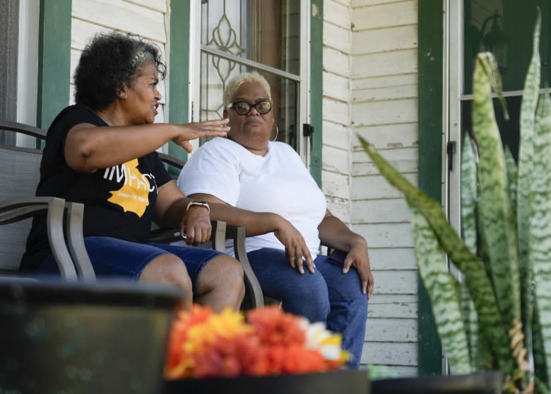 Leisa Glenn (left) visits with Mary Hutchins on Hutchins’ front porch. While Glenn has moved out of the neighborhood, Hutchins remains. (Jason Fochtman/Houston Chronicle via Getty Images)