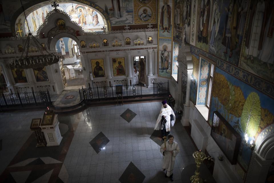 In this photo taken on Saturday, May 30, 2020, Father Vasily Gelevan conducts a service at the empty Church of the Annunciation of the Holy Virgin in Sokolniki, in Moscow, Russia. Russian Orthodox Churches in Moscow have been closed for parishioners since April 13 due to the coronavirus pandemic. (AP Photo/Alexander Zemlianichenko)