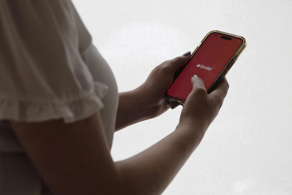 The dating app Tinder is shown on a smartphone on Wednesday, June 26, 2024, in New York. Plenty of happy couples can trace their meet-cute moment to an online dating app. But many others find the never-ending process of likes, swipes, taps and awkward DMs that go nowhere to be exhausting. (AP Photo/Peter Morgan)