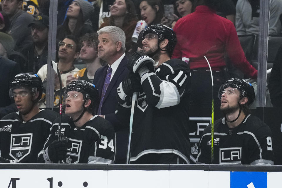 Los Angeles Kings center Anze Kopitar (11) reacts as he is recognized for breaking the team's record for number of games played during the first period of an NHL hockey game against the Boston Bruins Saturday, Oct. 21, 2023, in Los Angeles. (AP Photo/Ashley Landis)