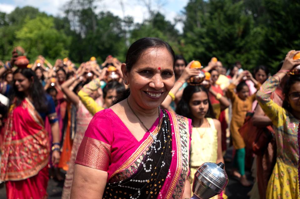 Community members walk around the building while singing, dancing, playing instruments and ringing a bell as a part of the Prana Pratishtha, grand opening, activities at Samarpan Hindu Temple & Community Center in Bensalem on Friday, June 24, 2022.
