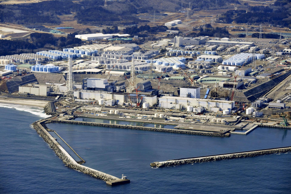 This Feb. 13, 2021, aerial photo shows Fukushima Daiichi nuclear power plant in Okuma town, Fukushima prefecture, north of Tokyo, Tuesday, April 13, 2021, Japan's government said Tuesday, April 13, 2021 it has decided to start releasing massive amounts of radioactive water stored in tanks at the wrecked Fukushima nuclear plant in two years after treatment. (Kyodo News via AP)