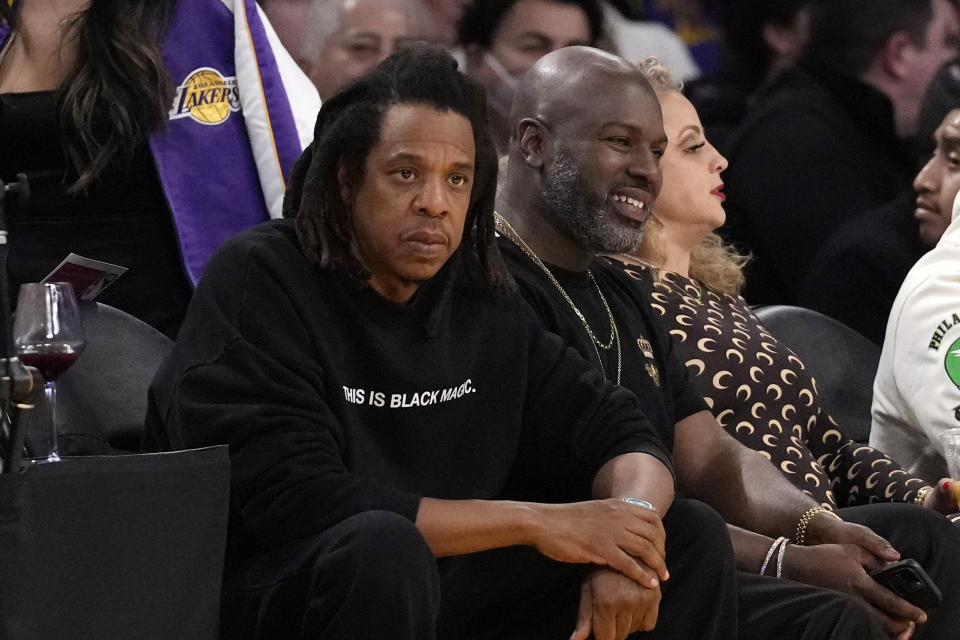 JAY-Z, left, watches during the first half of an NBA basketball game between the Los Angeles Lakers and the Oklahoma City Thunder Tuesday, Feb. 7, 2023, in Los Angeles. (AP Photo/Ashley Landis)