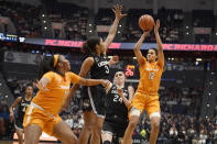 Tennessee's Rae Burrell (12) shoots over Connecticut's Megan Walker (3) and Connecticut's Anna Makurat (24) as Tennessee's Kasiyahna Kushkituah (11) defends in the first half of an NCAA college basketball game, Thursday, Jan. 23, 2020, in Hartford, Conn. (AP Photo/Jessica Hill)