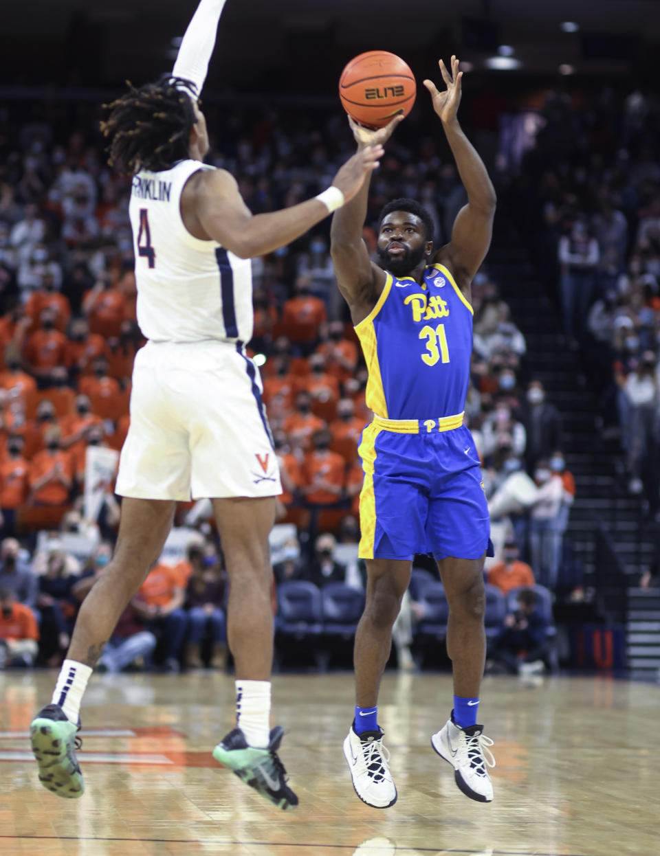 Pittsburgh guard Onyebuchi Ezeakudo (31) shoots over Virginia guard Armaan Franklin (4) during an NCAA college basketball game in Charlottesville, Va., Friday, Dec. 3, 2021. (AP Photo/Andrew Shurtleff)