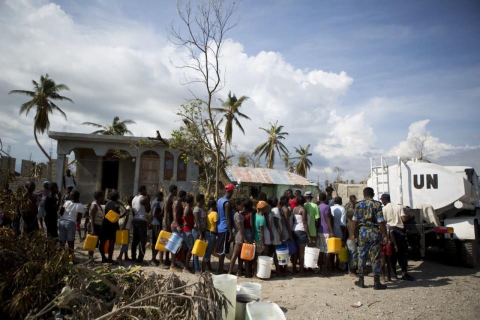 <p>United Nations police from Bangladesh deliver drinking water to residents of Sous-Roche village, outside Les Cayes, Haiti, Tuesday, Oct. 11, 2016. (AP Photo/Rebecca Blackwell)</p>