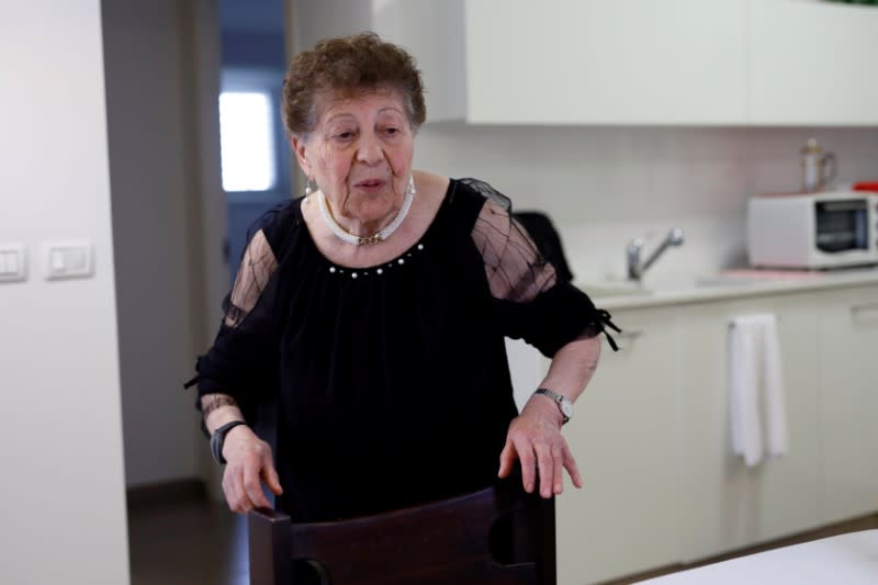 Holocaust survivor Artemis Miron, 91, walks in her kitchen during an interview with Reuters in Kfar Saba, Israel