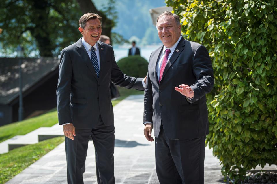 Slovenia's President Borut Pahor, left, welcomes US Secretary of State Mike Pompeo upon his arrival prior to their meeting in Bled, Slovenia, Thursday, Aug. 13, 2020. Pompeo is on a five-day visit to central Europe with a hefty agenda including China's role in 5G network construction. (Jure Makovec/Pool Photo via AP)