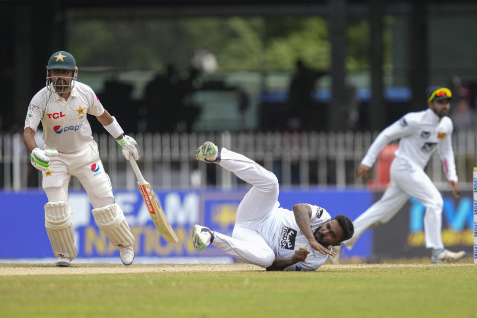 Sri Lanka's Asitha Fernando attempts to field the ball as Pakistan's Babar Azam watches during the second day of the second cricket test match between Sri Lanka and Pakistan in Colombo, Sri Lanka on Tuesday, Jul. 25. (AP Photo/Eranga Jayawardena)