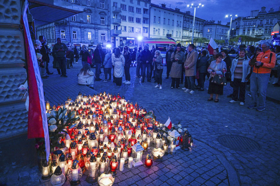 Friends and residents gather to place candles and flowers in honor of Damian Soból, a Polish food aid worker who was killed with six other World Central Kirchen workers by Israeli airstrike in Gaza this week, in Soból's hometown of Przemysl, in southeastern Poland, on Thursday, April 4, 2024. Poland is demanding that Israel pay compensation to the family of the killed charity worker and is urgently awaiting explanations from Israel of why the convoy was shelled. (AP Photo)