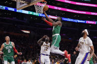 Boston Celtics guard Jaylen Brown shoots the ball past Los Angeles Lakers forward Taurean Prince (12) during the first half of an NBA basketball game, Monday, Dec. 25, 2023, in Los Angeles. (AP Photo/Ryan Sun)
