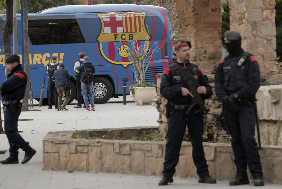 A bus carrying the Barcelona players leaves the Camp Nou stadium, ahead of a Spanish La Liga soccer match between Barcelona and Real Madrid in Barcelona, Spain, Wednesday, Dec. 18, 2019. Thousands of Catalan separatists are planning to protest around and inside Barcelona's Camp Nou Stadium during Wednesday's match against fierce rival Real Madrid. (AP Photo/Joan Mateu)