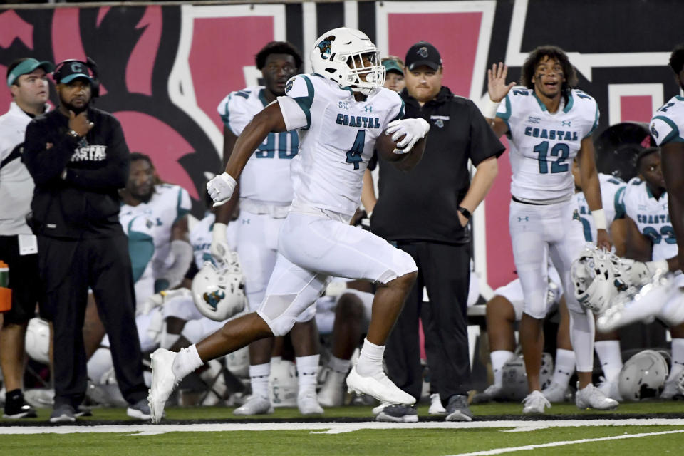 FILE - Coastal Carolina tight end Isaiah Likely (4) runs for a touchdown against Arkansas State during the second half of an NCAA college football game in Jonesboro, Ark., in this Thursday, Oct. 7, 2021, file photo. Likely was selected to The Associated Press Midseason All-America team, announced Tuesday, Oct. 19, 2021. (AP Photo/Michael Woods, File)