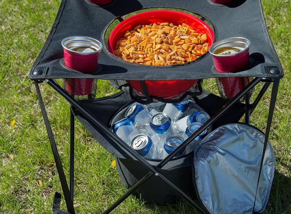 Tailgate table with snack mix and drinks.