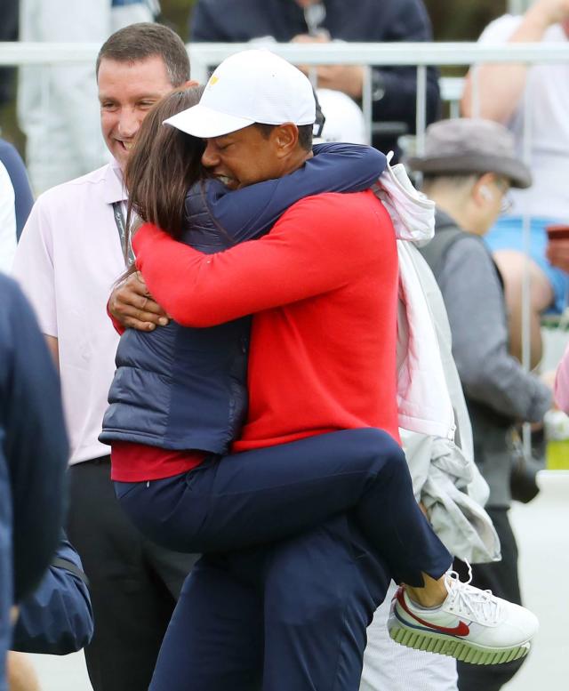 Tiger Woods of the United States team celebrates with girlfriend Erica Herman after defeating Abraham Ancer of Mexico and the International team 3&amp;2 during Sunday Singles matches on day four of the 2019 Presidents Cup at Royal Melbourne Golf Course on December 15, 2019 in Melbourne, Australia