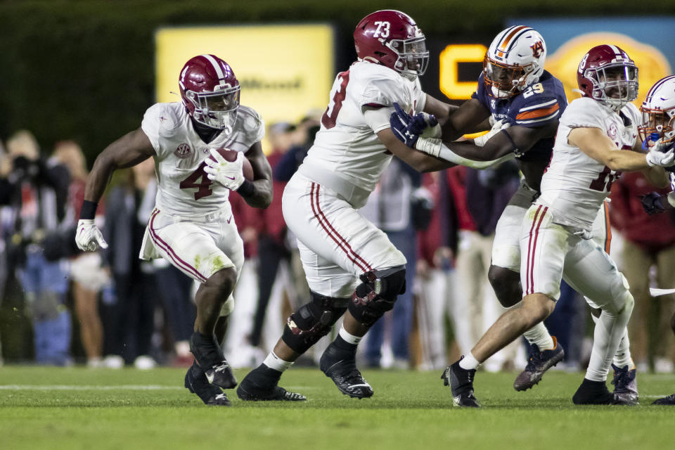 Alabama running back Brian Robinson Jr. (4) starts a long run that ended with an injury, from which he did not return, during the second half of an NCAA college football game against Auburn, Saturday, Nov. 27, 2021, in Auburn, Ala. (AP Photo/Vasha Hunt)