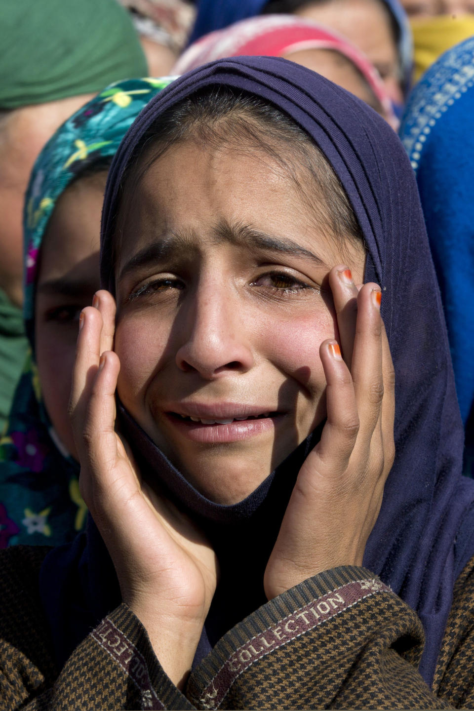 In this Saturday, Dec. 15, 2018, file photo, a Kashmiri girl grieves as she watches the funeral of Murtaza, a 14-year-old boy, in Pulwama, south of Srinagar, Indian controlled Kashmir. At least seven civilians were killed and nearly two dozens injured when government forces fired at anti-India protesters in disputed Kashmir following a gunbattle that left three rebels and a soldier dead on Saturday, police, and residents said. (AP Photo/Dar Yasin, File)