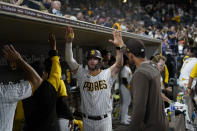San Diego Padres' Wil Myers, center, celebrates with teammates after hitting a home run during the eighth inning of a baseball game against the San Francisco Giants, Tuesday, Oct. 4, 2022, in San Diego. (AP Photo/Gregory Bull)