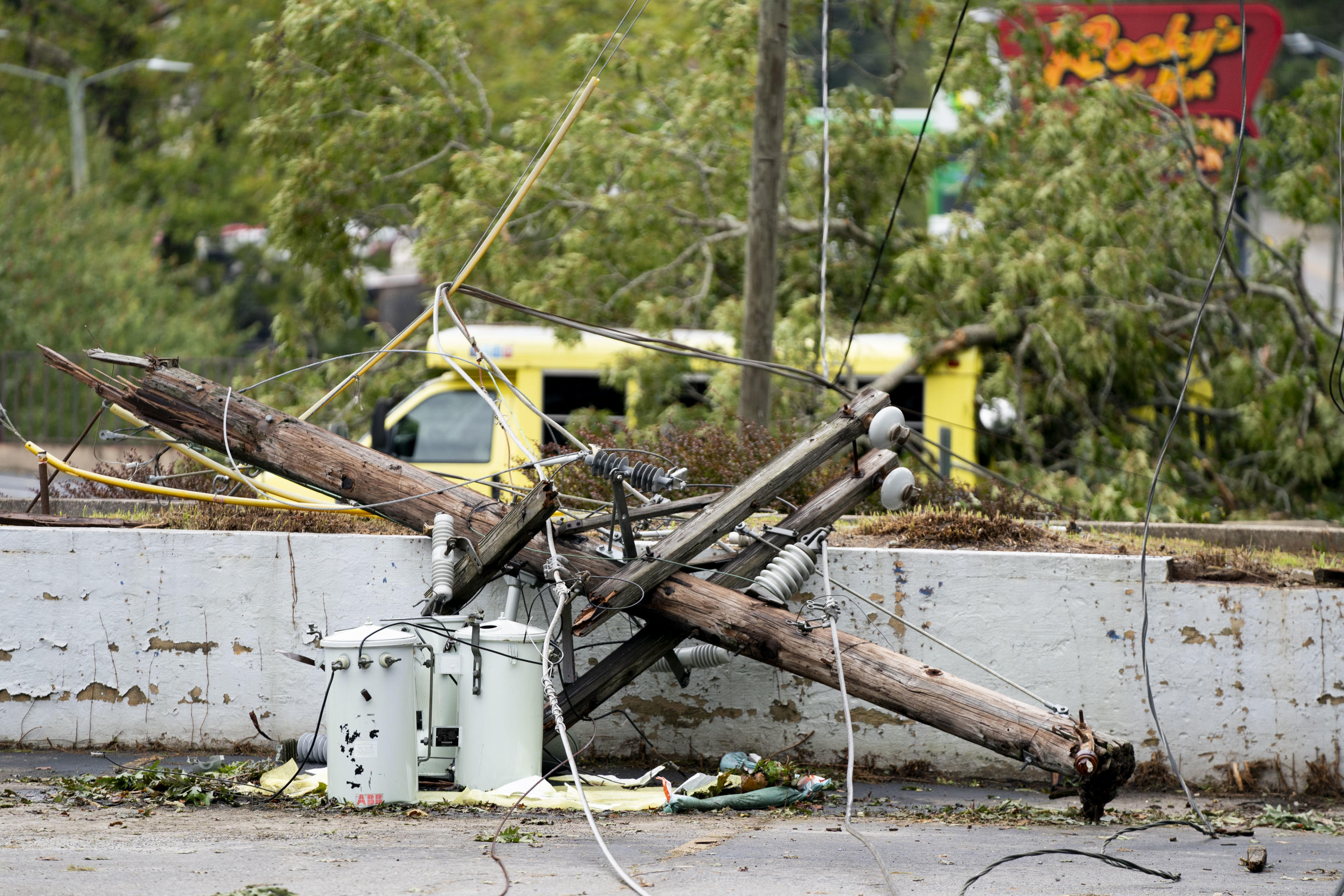 A broken utility pole in Asheville, North Carolina amidst downed power lines.