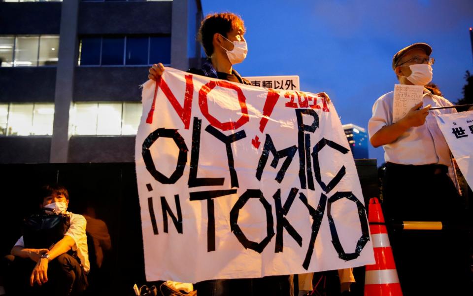 Anti-Olympic protesters gather outside Japanese Prime Minister Yoshihide Suga's office in Tokyo, Japan on 29 July 2021 - Androniki Christodoulou/Reuters