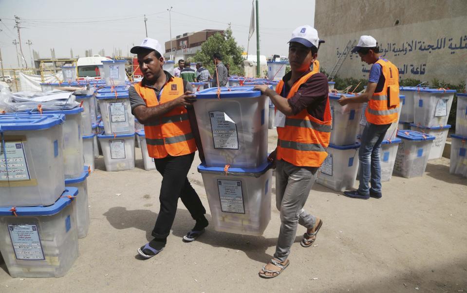 Electoral workers carry ballot boxes at a counting center in Basra, Iraq's second-largest city, 340 miles (550 kilometers) southeast of Baghdad, Iraq, Thursday, May 1, 2014. Iraq voted Wednesday in its first nationwide election since U.S. troops withdrew in 2011, with Prime Minister Nouri al-Maliki confident of victory and even offering an olive branch to his critics by inviting them to join him in a governing coalition. (AP Photo/ Nabil Al-Jurani)