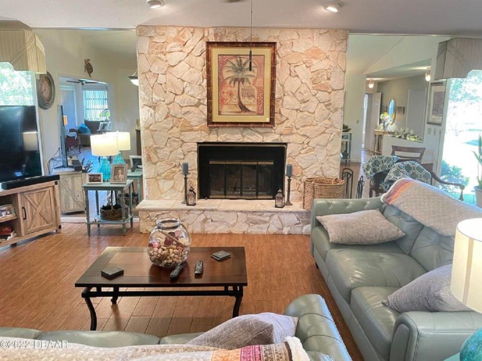 A stone fireplace is the centerpiece of the great room in this Pelican Bay home, which boasts 2,455 square feet of living space.