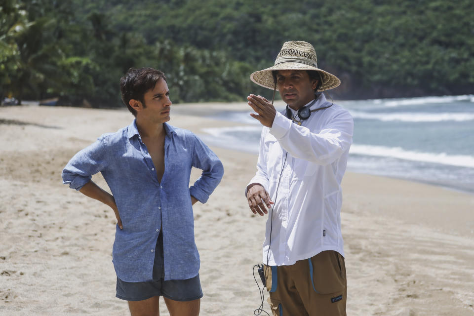 This image released by Universal Pictures shows Gael García Bernal, left, and filmmaker M. Night Shyamalan on the set of "Old." (Universal Pictures via AP)