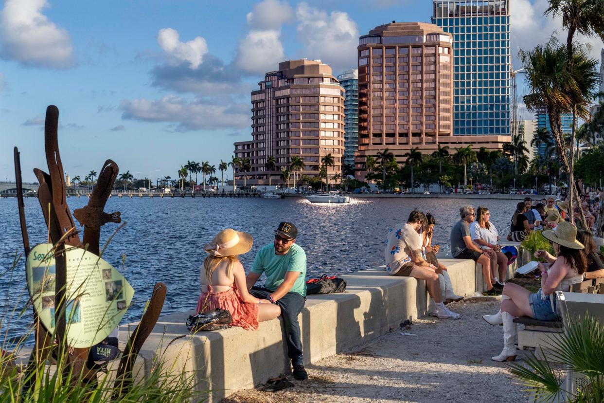 Visitors relax on West Palm Beach's waterfront at SunFest on May 4.