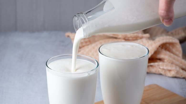 pouring buttermilk into two glasses