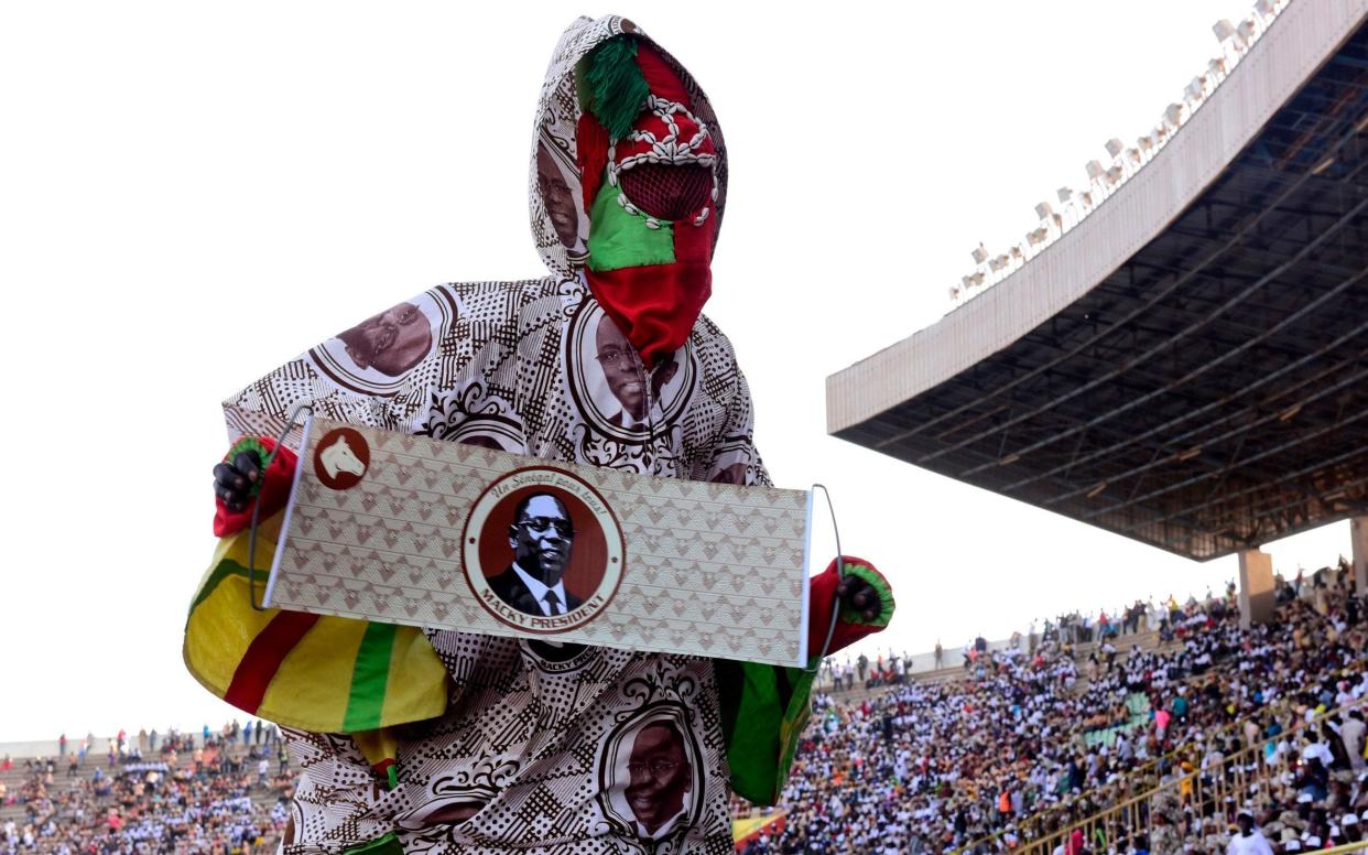 A supporter of outgoing Senegalese president and candidate Macky Sall takes part in the meeting closing his electoral campaign - AFP