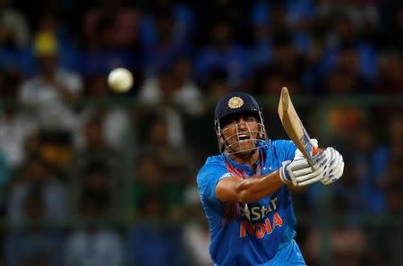 Cricket - India v England - Third T20 International - M Chinnaswamy Stadium, Bengaluru, India - 01/02/17. India's Mahendra Singh Dhoni plays a shot. REUTERS/Danish Siddiqui