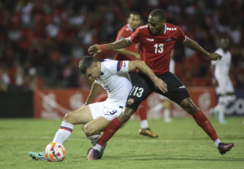 United States' Ricardo Pepi, left, fights for the ball with Trinidad and Tobago's Reon More, right, during a CONCACAF Nations League quarterfinal soccer match at Hasely Crawford Stadium in Port of Spain, Trinidad and Tobago, Monday, Nov. 20, 2023. (AP Photo/Azlan Mohammed)