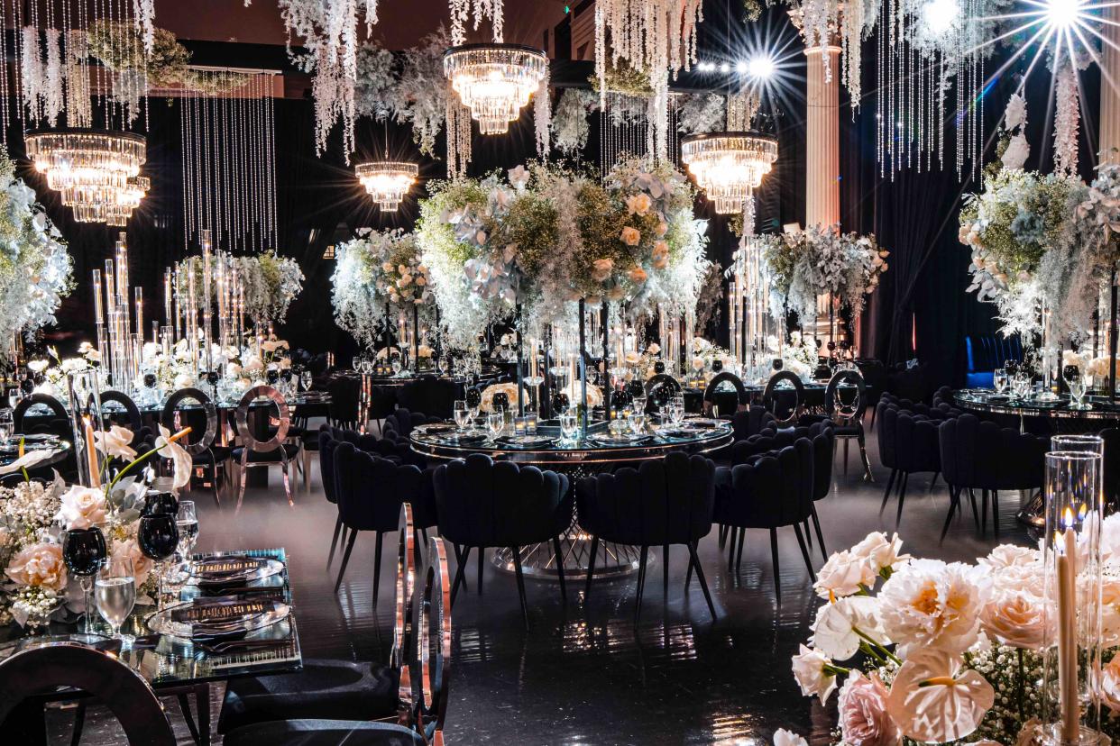 The decadent dinner setting was meticulously planned, with huge flower arrangements. (Michael Anthony Studios)