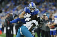Jacksonville Jaguars safety Rayshawn Jenkins (2) pushes Detroit Lions tight end Shane Zylstra (84) out of bounds during the second half of an NFL football game, Sunday, Dec. 4, 2022, in Detroit. (AP Photo/Duane Burleson)